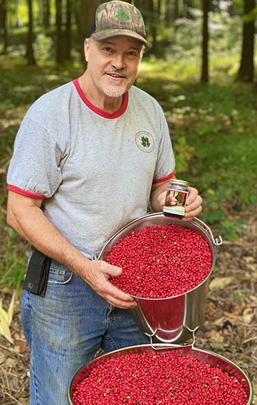 Larry with Ginseng Berries and Jar of Ginseng Berry Concentrate
